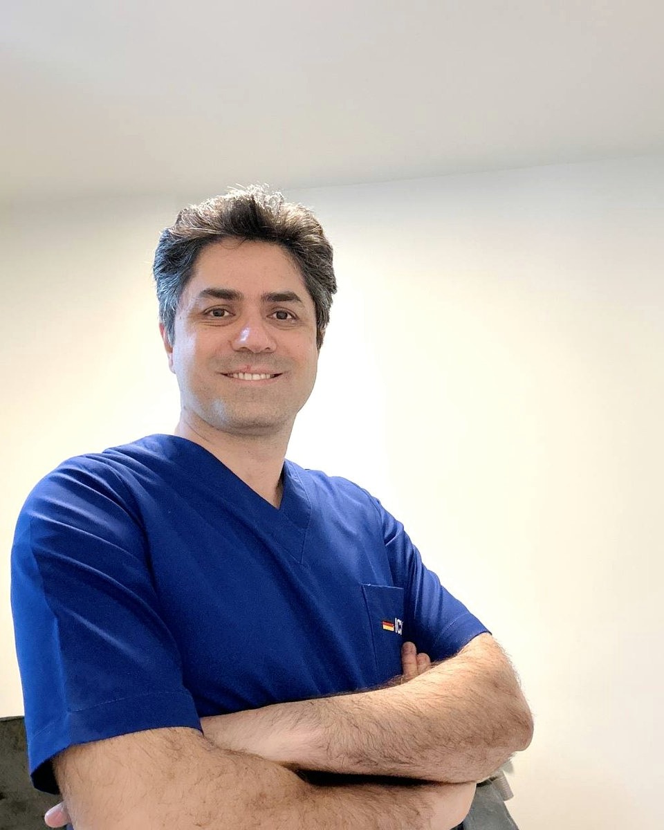 Dr. Mohammad Hosseinian in blue clinical scrubs